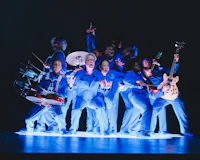 a group of people in blue suits on stage